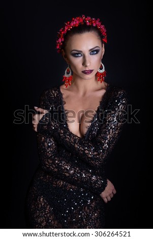 expensive jewelry wreath earrings and ring on a beautiful sexy elegant brunette girl with a bright evening make-up in a black evening dress with lace
