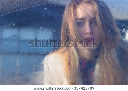 sad beautiful seksalnaya Pretty sad lonely girl behind wet glass with big sad eyes in a coat