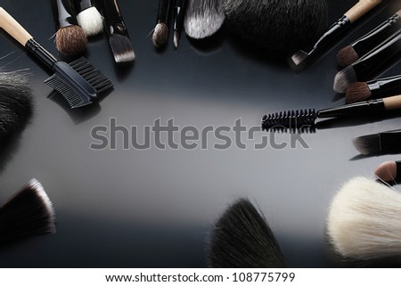 Collection of make-up brushes on black  background
