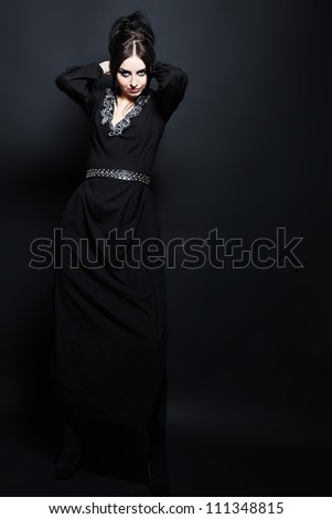 Portrait of a mystical woman in an elegant black dress