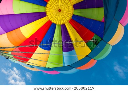 Beautiful vivid and vibrant colors of a hot air balloon. Exciting flying experience in the blue sky.
