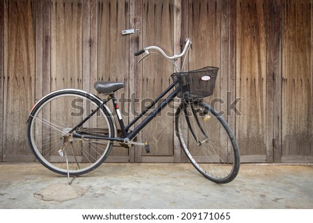 Vintage Bicycle standing near a vintage wood wall