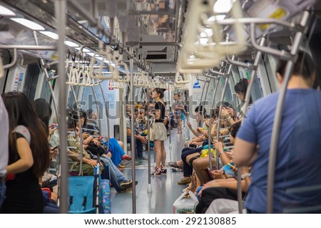 SINGAPORE-JUNE 26: Unidentified people on the Mass Rapid Transit train in Singapore on June 26, 2015. The Mass Rapid Transit has 102 stations and is the second-oldest metro system.
