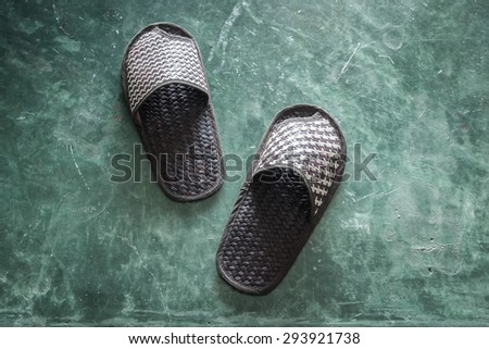 Pair of brown shoes for in room on cement floor in bed room