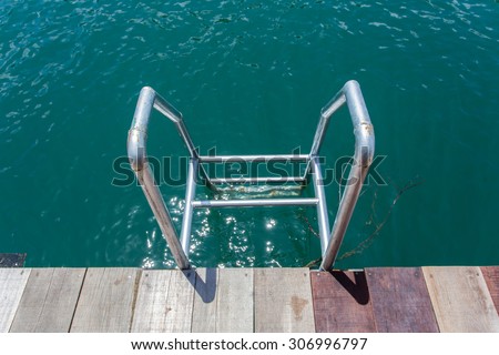Grab bars ladder in lake forest and river natural attractions in Ratchaprapha Dam at Khao Sok National Park, Surat Thani Province, Thailand.