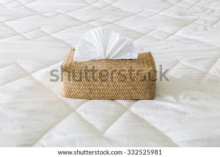 Tissues in bamboo box on the bed