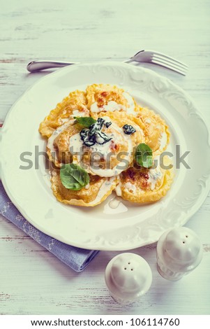 Panzerotti with blue cheese sauce and spinach (vintage stylized)