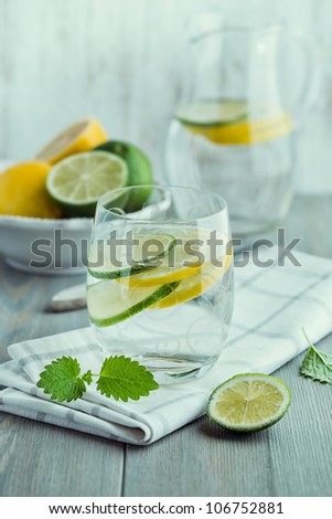 Glass of cold water with lemon and lime