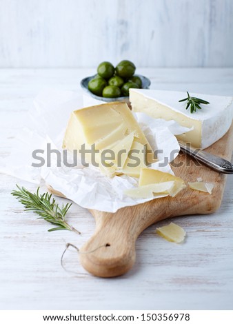 Pecorino and brie cheese on a kitchen board