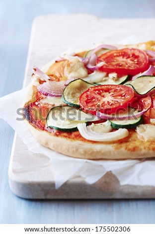 Vegetable pizza with zucchini, tomato and onion