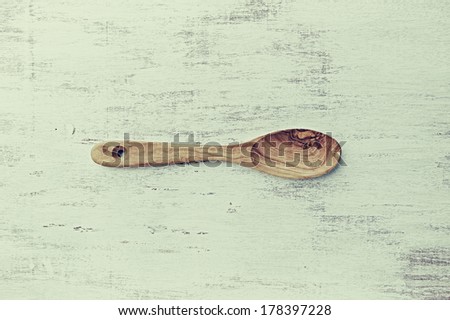 Olive Wood Spoon on Shabby Background (old fashioned)