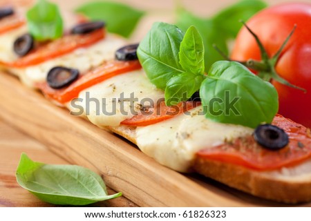 Baked baguette with mozzarella and tomatoes