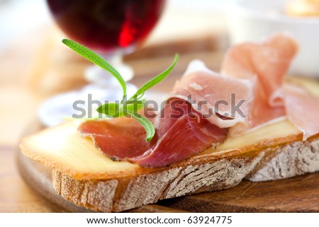 Delicious canape with french cheese and prosciutto
