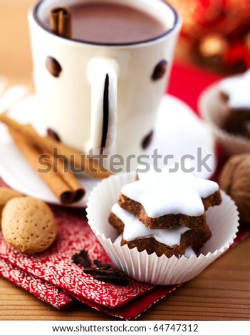 Cinnamon cookies and hot chocolate with cinnamon sticks
