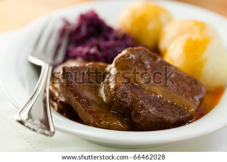 Roast beef with potato dumplings and red cabbage