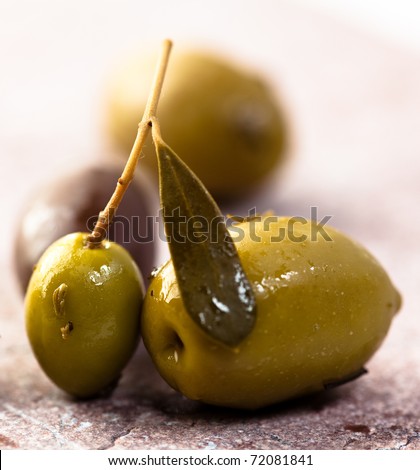 Marinated greek olives on stone background