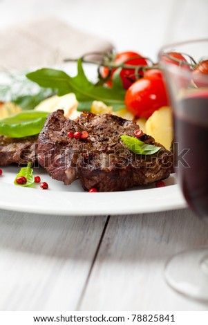 Rustic dinner with grilled beef and vegetables