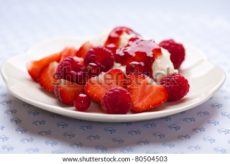 Fresh red fruits and mascarpone cream with fruit sauce