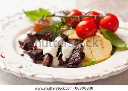 Rustic beef dish with cherry tomatoes