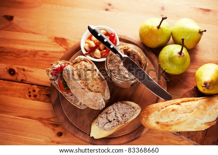 Rustic dinner with bread rolls, pate and pears