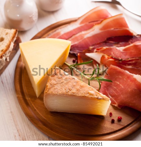Italian hard cheese and cold cuts on kitchen board