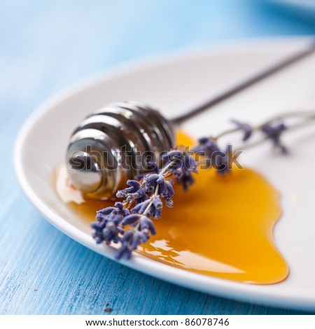 Lavender honey and honey dipper on a plate