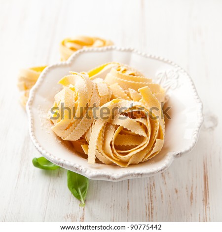Raw italian pasta in a bowl (pasta all\'uovo- egg pasta)