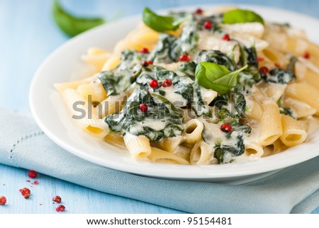 Penne pasta with blue cheese sauce and spinach