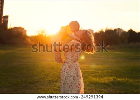 happy mother and son at sunset sunlight