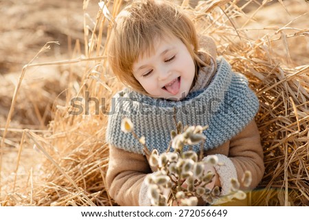 Portrait of little girl sticking out tongue on the nature