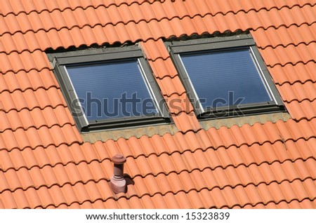 Classic garrets on a red tile roof.