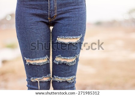 Woman in torn jeans