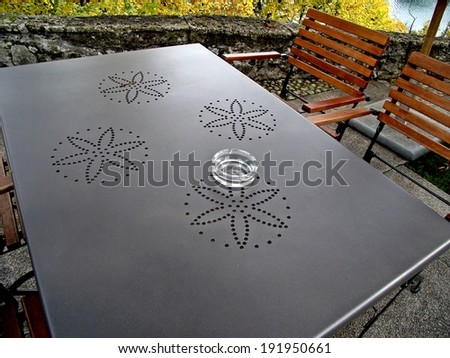 Tranquil scene of bar table and chairs under a tree