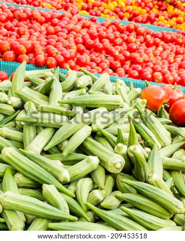 Okra and cherry tomatos at a vegetable sellers stall.