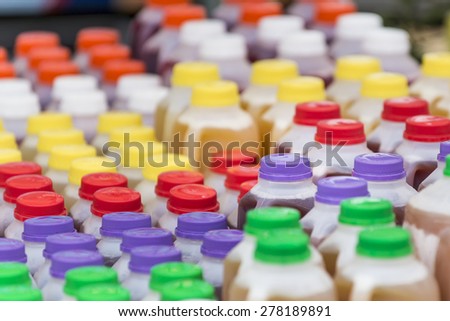 Plastic bottles of apple ciders with colored caps.