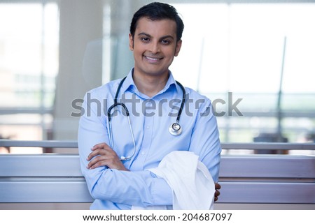 Closeup portrait of friendly, smiling confident male doctor, healthcare professional with stethoscope around neck, arms crossed. Patient visit. Health care reform.
