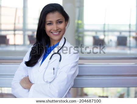 Closeup portrait of friendly, smiling confident female doctor, healthcare professional with labcoat and stethoscope, arms crossed. Patient visit. Health care reform.