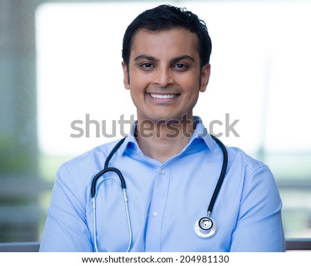 Closeup portrait of friendly, smiling confident male doctor, healthcare professional with stethoscope around neck, arms crossed.