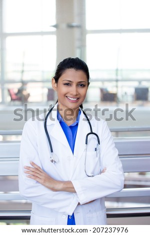 Closeup portrait of friendly, smiling confident female doctor, healthcare professional with labcoat and stethoscope, arms crossed. Patient visit.