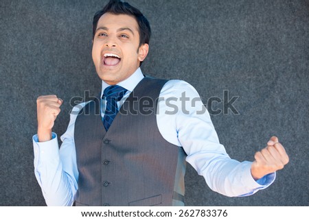 Closeup portrait, handsome excited, energetic, happy, smiling boss man winning, arms, fists pumped, celebrating success, isolated gray silver background. Positive emotion, facial expressions