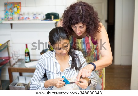 Closeup portrait, teacher showing how to create fine arts and craft on mixed media canvas, isolated indoors art studio background