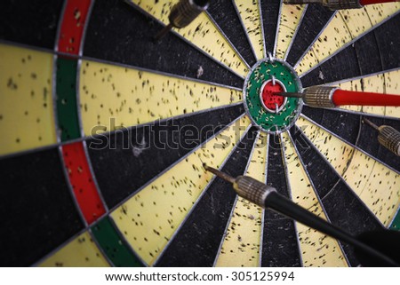 Dart-board and red darts