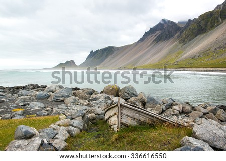 Beautiful coast Stokksnes with old boat. View to the Atlantic ocean and mountains, East Iceland