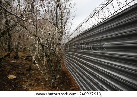 Krasnodar region, Russia - March 23, 2012. Fence villas Governor Tkachev in the protected forest with trees, listed in the Red book