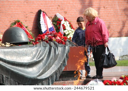 Moscow, Russia - May 9, 2012. People lay flowers at the Eternal flame in Aleksandrovsk to a garden in the Victory Day