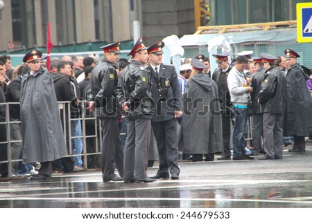 Moscow, Russia - May 9, 2012. March of communists on the Victory Day. The Russian police during a rain, near procession of communists