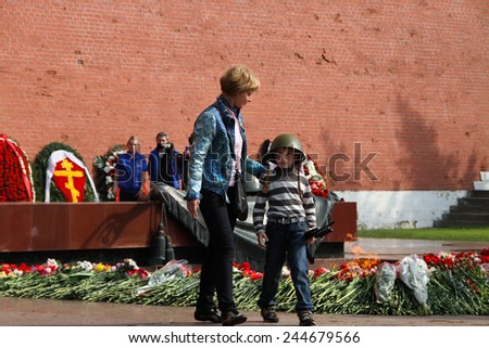 Moscow, Russia - May 9, 2012. People lay flowers at the Eternal flame in Aleksandrovsk to a garden in the Victory Day