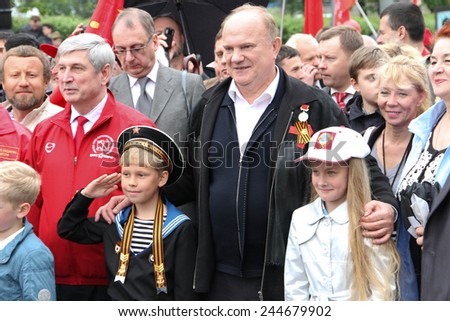 Moscow, Russia - May 9, 2012. March of communists on the Victory Day. The leader of communist party of Russia Gennady Zyuganov is photographed with children