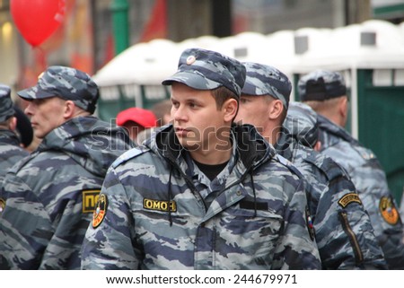 Moscow, Russia - May 9, 2012. March of communists on the Victory Day. Staff of the Russian police protects political procession