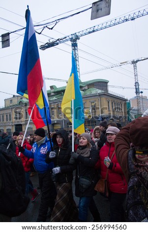 Moscow, Russia - March 1, 2015. Russian and Ukrainian flags together for the funeral March of the opposition to the memory of Boris Nemtsov. March to the memory of Boris Nemtsov
